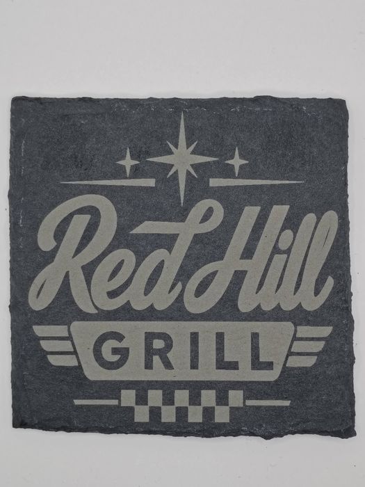 Slate coaster engraved with the Red Hill Grill logo