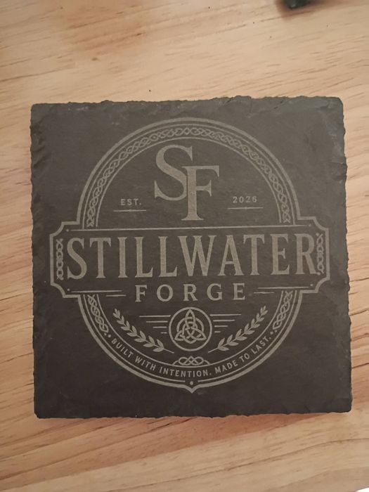 Slate coaster engraved with the Stillwater Forge crest