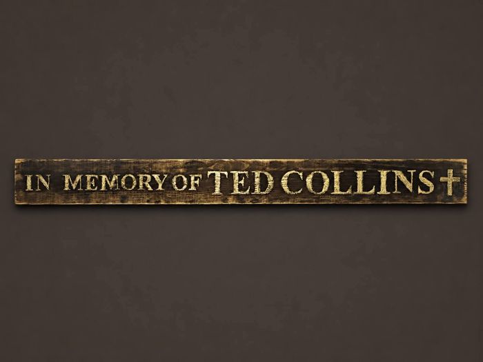Memorial plaque reading In Memory of Ted Collins in gold lettering