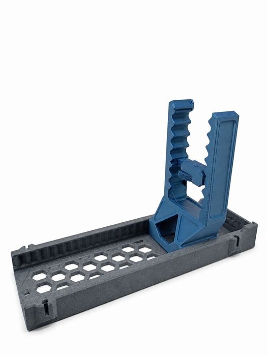 Blue and gray adjustable pistol display stand with a toothed clamp arm on a vented base